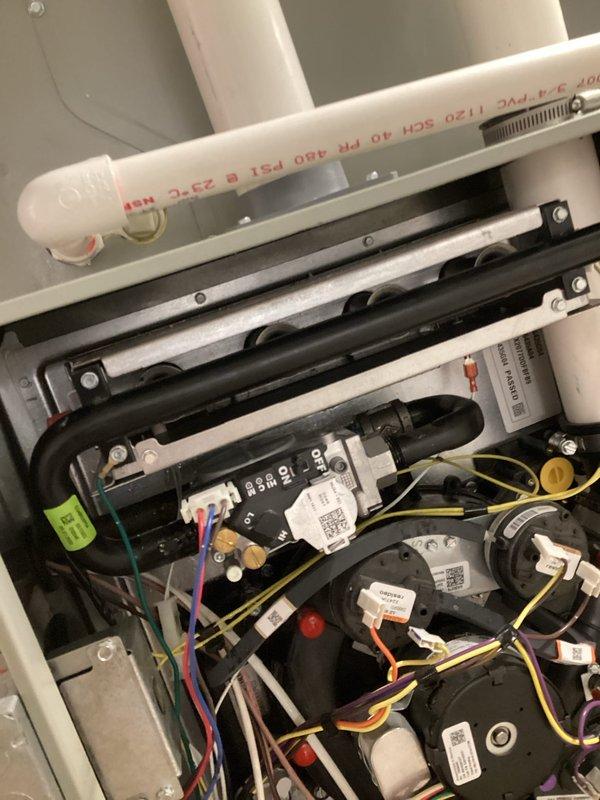 Inspected HVAC system due to reported gas leak. Conducted thorough examination of gas line components including the main PVC supply line and black rubber gas hose with green identification label. Checked all connections, brackets, and electrical components associated with the gas system, confirming proper installation and sealing of all gas-carrying components.