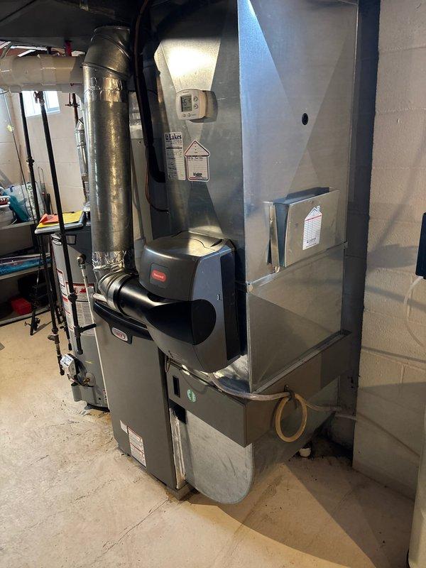 Successfully completed a Lennox furnace retrofit in basement utility area. Installed new unit with proper PVC exhaust venting connected to existing metallic ductwork system. All connections secured and system tested for optimal performance.