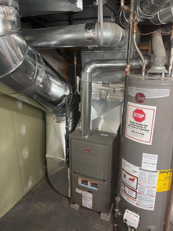 Completed retrofit installation of a Lennox furnace in basement utility room, connecting to existing ductwork system. Verified proper integration with Rheem water heater and ensured all ventilation components were properly sealed and functioning according to manufacturer specifications.