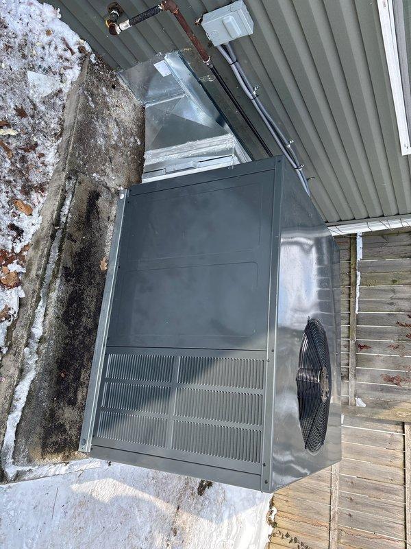 Completed replacement of existing package unit with new RTU installation. Mounted unit on wooden platform, connected metal ductwork system to building, and installed electrical connections including conduit with proper mounting brackets. Secured all copper refrigerant lines and verified proper installation of all components.