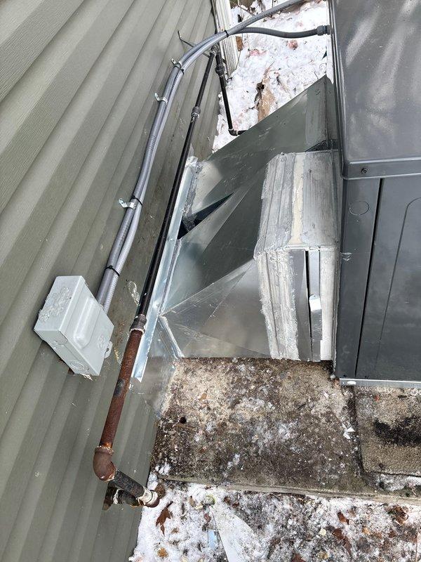 Completed replacement of existing package unit with new RTU installation. Mounted unit on wooden platform, connected metal ductwork system to building, and installed electrical connections including conduit with proper mounting brackets. Secured all copper refrigerant lines and verified proper installation of all components.