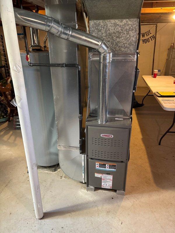 Successfully completed installation of a new Lennox furnace in basement utility area. Installed complete metal ductwork system with proper ventilation connections, including vertical and horizontal galvanized components. System was fully tested and verified to be operating according to manufacturer specifications.