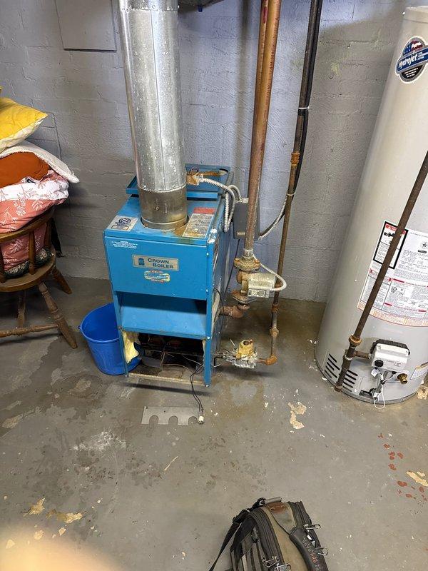 Responded to emergency service call for non-operational Crown boiler. Diagnosed failed circulator pump causing no heat distribution. Replaced pump, bled air from system, and verified proper operation of expansion tank. System now functioning with normal pressure and heat output.