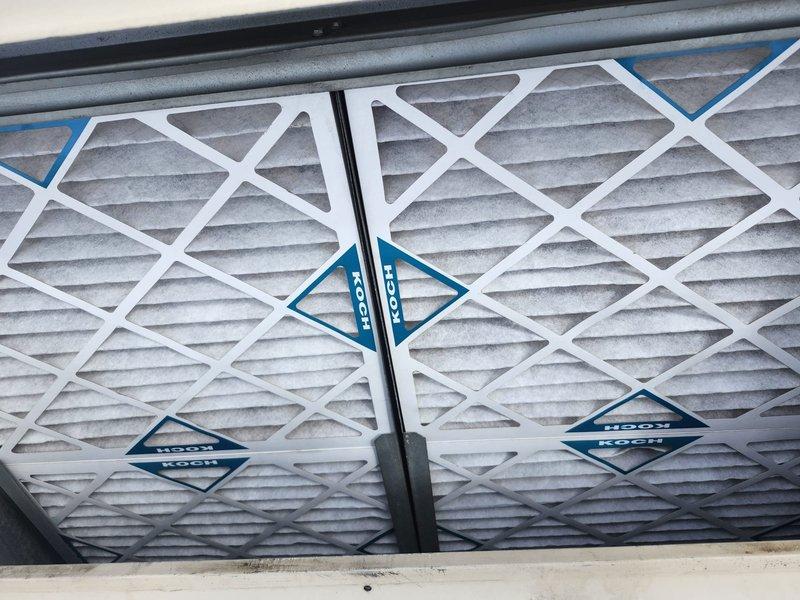 Responded to service call for commercial furnace not heating above 65°F. Inspected system and found dirty air filters restricting airflow. Replaced multiple KOCH filters in both main housing and ceiling/wall mounted air handling units. System now operating properly with improved airflow and heating capacity.