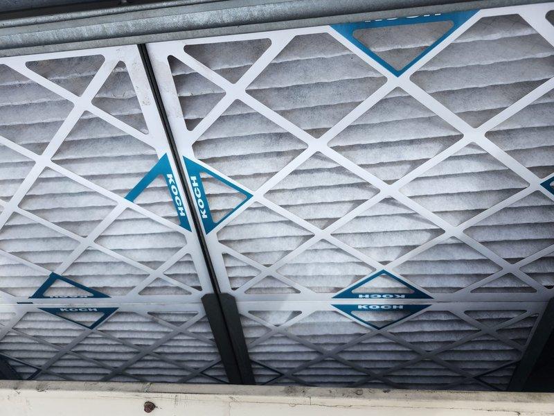 Responded to service call for commercial furnace not heating above 65°F. Inspected system and found dirty air filters restricting airflow. Replaced multiple KOCH filters in both main housing and ceiling/wall mounted air handling units. System now operating properly with improved airflow and heating capacity.