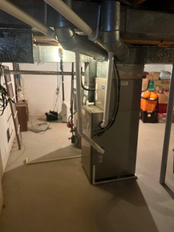 Conducted comprehensive inspection of existing HVAC system in basement utility area. Evaluated aging furnace unit with connected ductwork (both rectangular and circular) and assessed integration with water heater system. Recommended full system replacement due to efficiency concerns and outdated equipment.