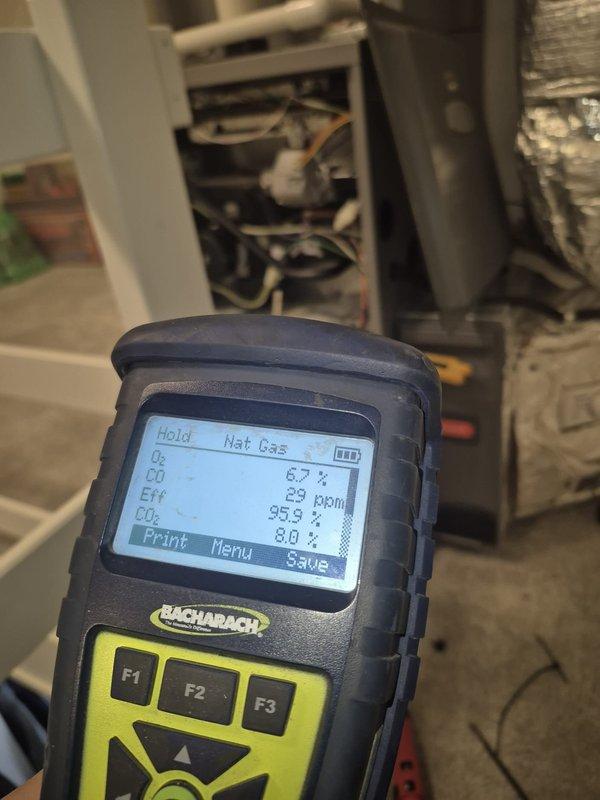 Performed diagnostic service on a Prestige triangular tube floor heating system. Combustion analysis showed optimal efficiency (95.9%) with acceptable O₂ (6.7%), CO₂ (8.0%), and CO (29 ppm) levels. Confirmed proper venting operation with normal exhaust plume visible from roof vent.