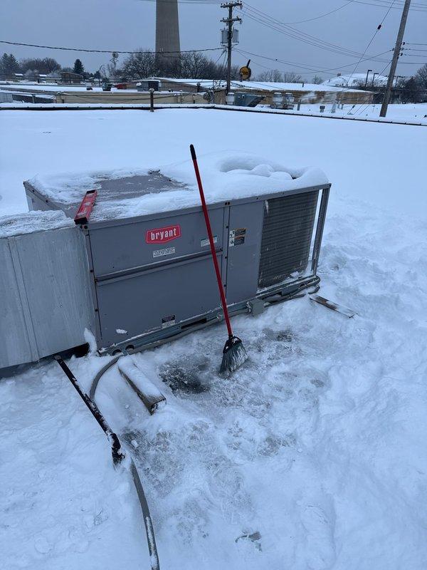 Successfully installed a Bryant RTU on commercial property during winter conditions. Cleared accumulated snow from unit and surrounding area to ensure proper ventilation and access. Completed installation with all electrical connections and verified system operation.