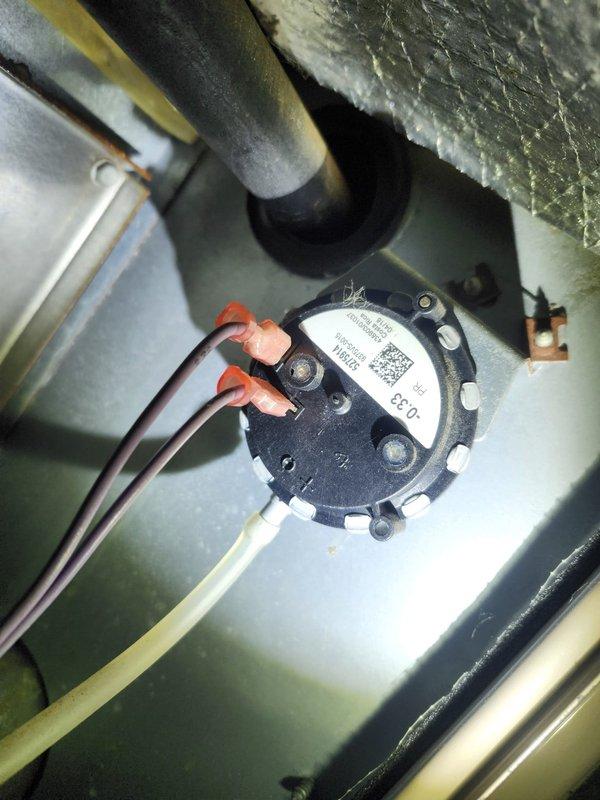 Responded to service call for RTU serving back half of building that was blowing cold air. Inspected system and found faulty pressure switch preventing ignition sequence. Also noted blower motor and assembly had significant dust buildup affecting airflow. Replaced pressure switch, cleaned blower wheel and motor components, restoring proper heating function.