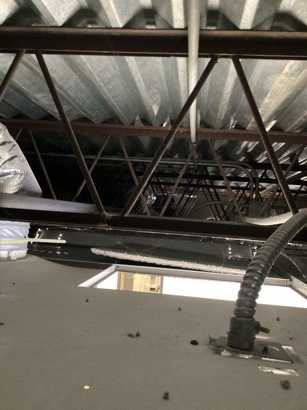 Conducted inspection of ceiling infrastructure to evaluate plumbing system integration requirements. Examined existing HVAC ductwork and copper pipe connections within the structural framework. Assessed overhead truss system and support beams for proper placement of new piping components and evaluated insulation needs for optimal system performance.