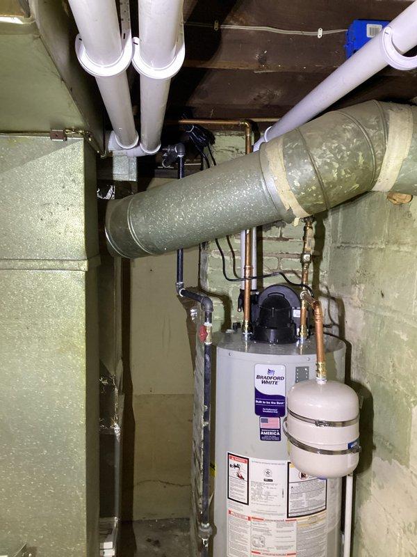 Successfully replaced existing furnace and installed new Bradford White water heater with expansion tank for Summit Co HWAP program. Complete installation included connecting all necessary plumbing (copper and PVC) and properly securing HVAC ductwork with appropriate insulation and tape sealing at joints. System was tested and verified operational in basement utility area.