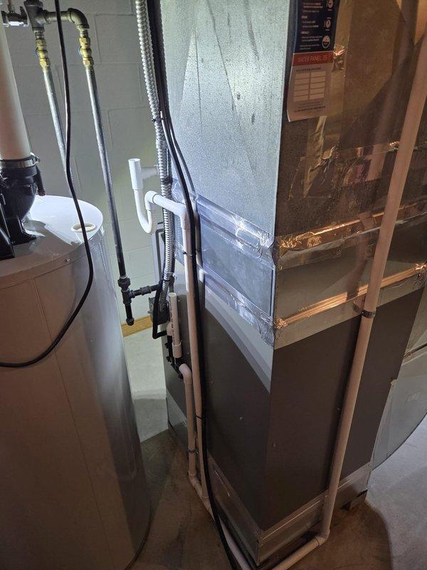 Successfully completed a furnace retrofit in basement utility room, installing a new HVAC system with proper ducting and exhaust connections. The installation included securing all necessary plumbing connections and ensuring proper venting against the existing concrete block wall.