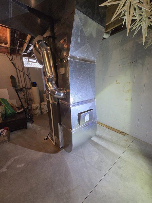 Successfully completed a furnace retrofit in basement utility room, installing a new HVAC system with proper ducting and exhaust connections. The installation included securing all necessary plumbing connections and ensuring proper venting against the existing concrete block wall.