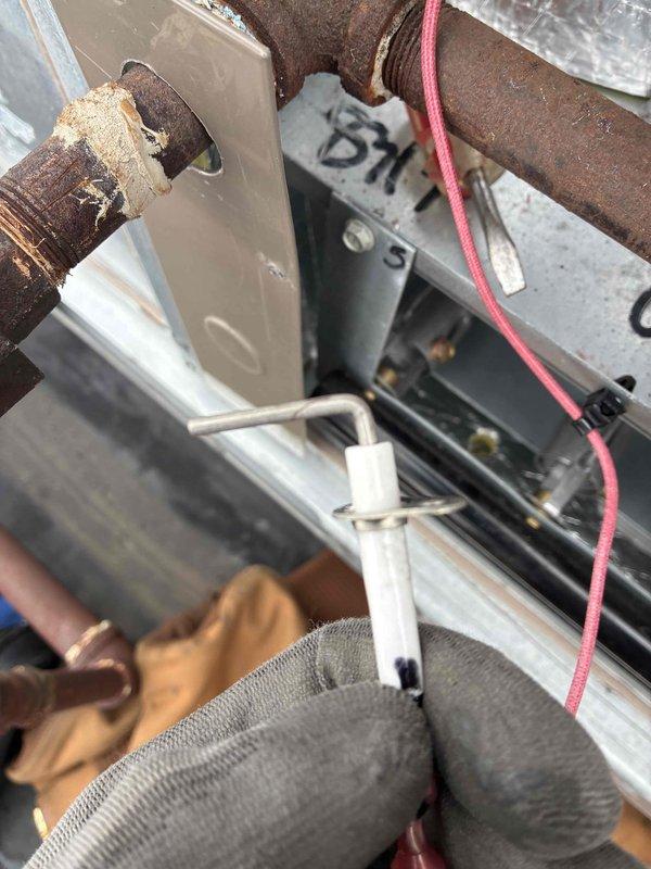 Performed scheduled commercial heating maintenance and identified significant corrosion on system piping. Removed and inspected temperature probe/sensor, which showed signs of wear. Documented condition with photos for future reference and customer records.