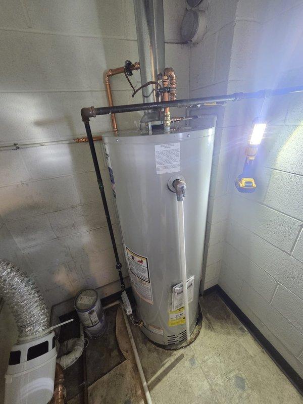 Successfully installed a new commercial tanked water heater in utility room with proper copper pipe connections and fittings, including pressure relief valve. Completed installation of metal flue pipe for proper venting, and ensured all connections were secure with no leaks upon final testing.