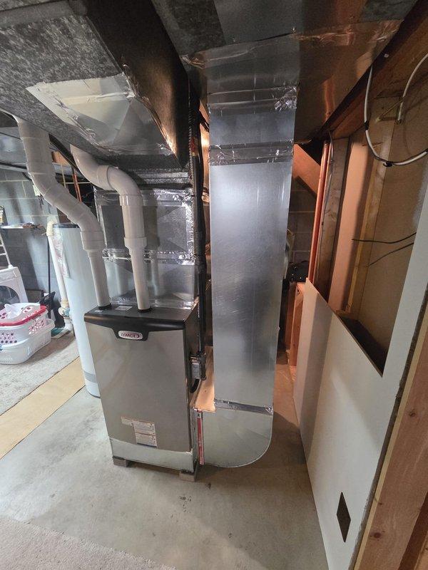 Successfully completed a Lennox furnace retrofit in residential basement utility area. Installed unit with properly sealed sheet metal ductwork connections and PVC condensate/venting system. Confirmed proper installation with adequate service clearance and verified system functionality alongside existing water heater.