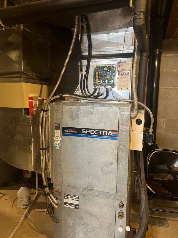 Conducted comprehensive inspection of existing dual Geothermal systems for conversion to Gas/AC configuration. Evaluated current SPECTRA furnace unit with associated control module and electrical connections in basement utility area. Documented system layout and ductwork configuration to prepare detailed replacement estimate for two complete HVAC system conversions.