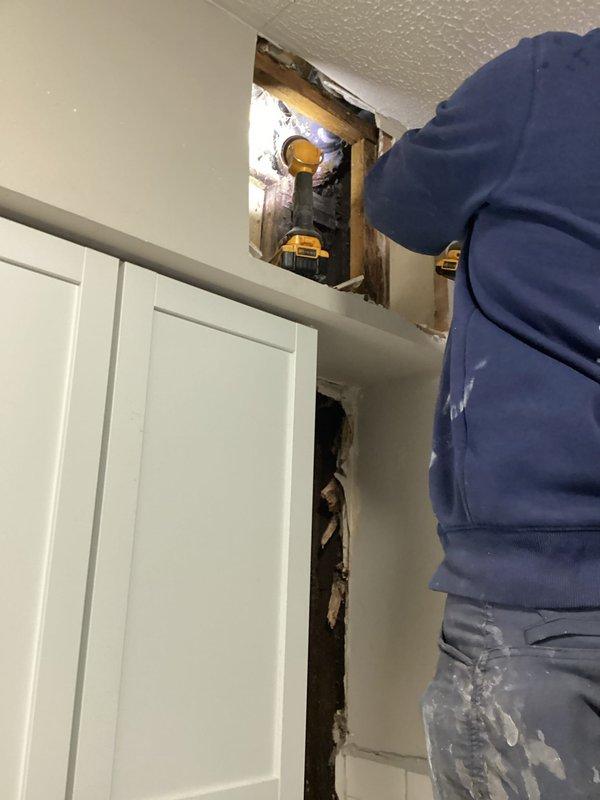 Opened wall behind dishwasher to investigate suspected furnco leak, utilized camera inspection to identify broken drain tile, then performed jackhammer work to access and repair damaged drain section. Customer confirmed partial payment arrangement has been made.