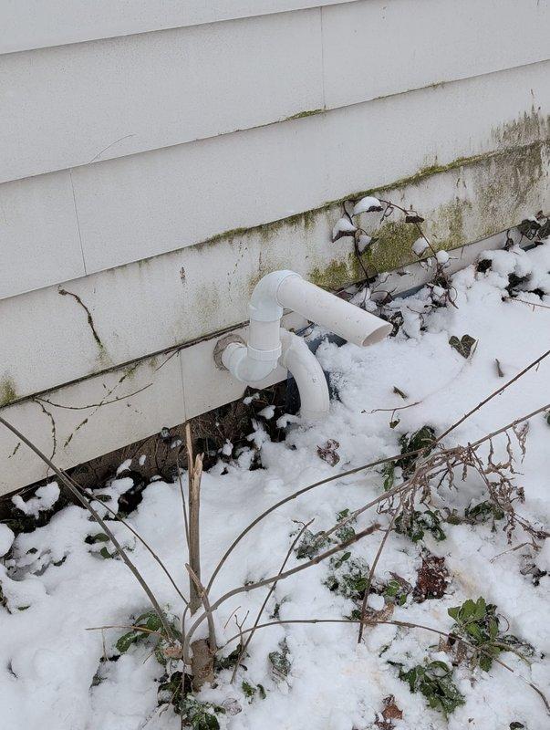 Completed Lennox furnace retrofit installation in basement mechanical room, including proper PVC venting through exterior wall. Installed unit features standard manufacturer specifications with appropriate connections to existing HVAC system and water heater. Exterior penetration properly sealed despite evidence of pre-existing moisture issues on siding.