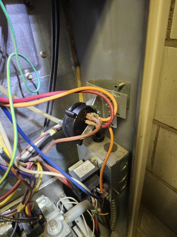 Responded to complaint of furnace not clicking on with erratic thermostat display and water line leak. Inspected control board and electrical components, finding loose wiring connections at the pressure switch. Repaired connections and addressed condensate drain line blockage to resolve water leak issue. System now operating properly with stable thermostat function.