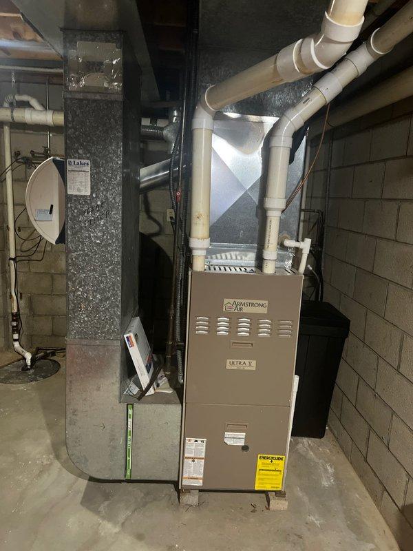 Completed furnace retrofit in basement utility area, installing a new Armstrong Air Ultra V furnace with appropriate PVC intake/exhaust ventilation system. All connections to existing ductwork were properly sealed and system was tested for proper operation after installation.