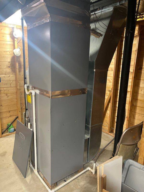 Completed furnace retrofit assessment for replacement of existing unit with larger capacity system. Current installation features an aging furnace with open access panel revealing internal components and PVC exhaust/intake pipes. Recommendation includes full system replacement due to age of components and customer's request for increased heating capacity.