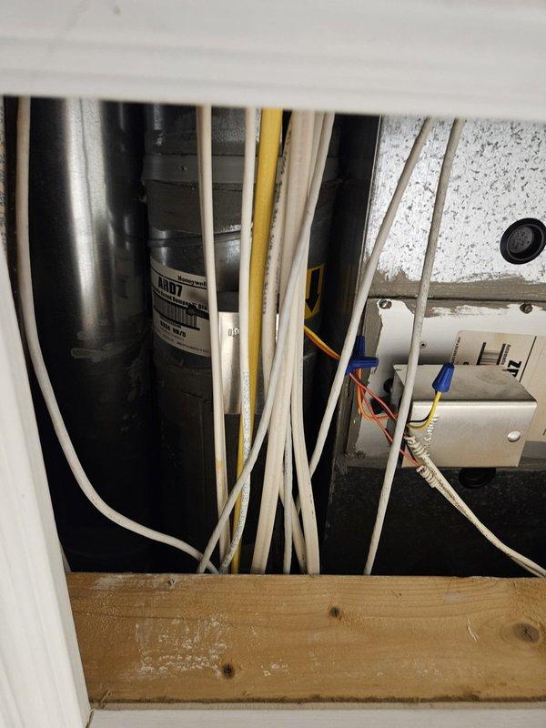 Responded to service call regarding humidifier detachment from newly installed furnace. Accessed unit through ceiling panel using ladder and confirmed no damage to furnace or surrounding components. Documented condition with photos showing wire connections and installation area for verification.