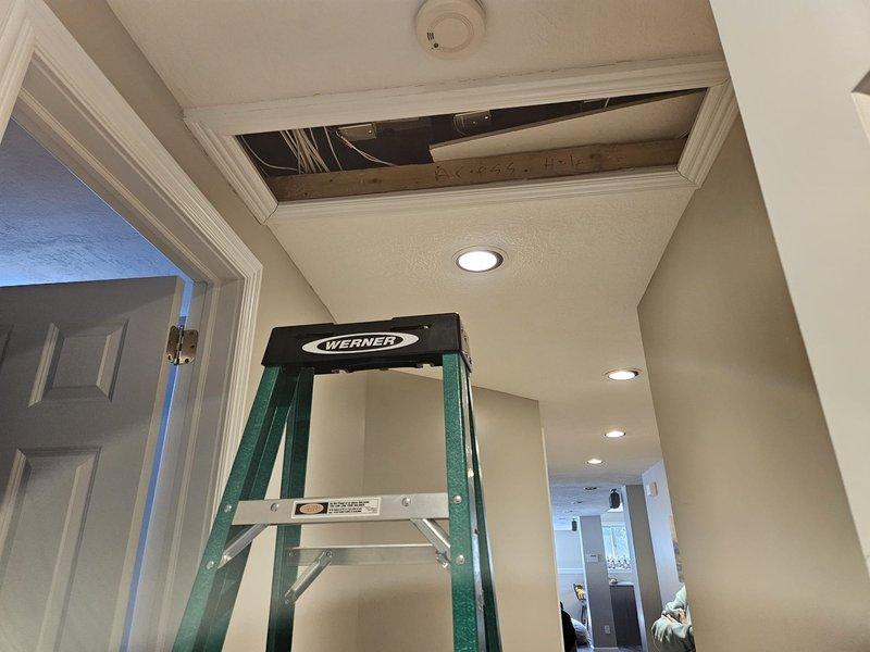 Responded to service call regarding humidifier detachment from newly installed furnace. Accessed unit through ceiling panel using ladder and confirmed no damage to furnace or surrounding components. Documented condition with photos showing wire connections and installation area for verification.