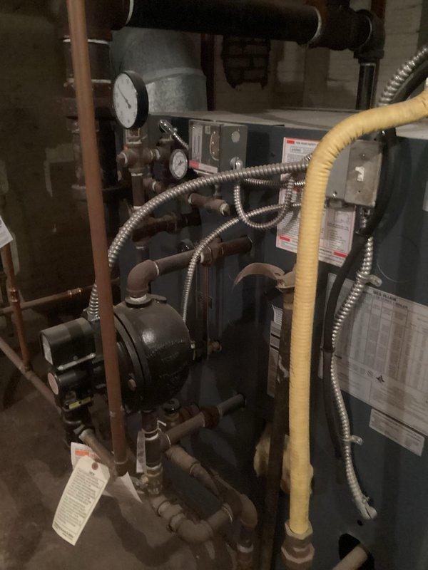 Performed comprehensive inspection on 10-year-old Weil-McLain LGB Series 2 boiler system. Visual examination revealed properly installed components including copper/black piping network, pressure gauges, and pump assembly all in working condition. Documented system specifications and component status with digital photography for service records.
