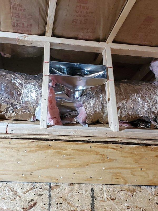 Conducted site inspection of new construction HVAC installation. Verified proper installation of insulated ductwork through framed openings with R13 insulation present, and confirmed appropriate placement of metal register boxes and vent connectors. All components appear correctly installed with proper sealing and insulation prior to drywall installation.