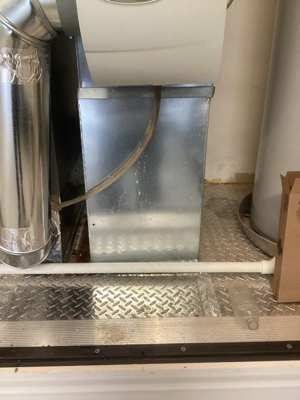 Responded to service call for water leak potentially originating from humidifier. Upon inspection of the HVAC system installation and surrounding plumbing, identified and documented PVC pipe drainage configuration passing through the diamond plate flooring. Performed thorough assessment of the mechanical equipment and connections to ensure proper functionality.