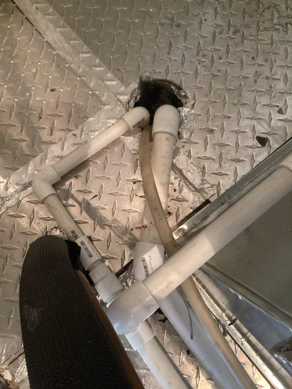 Responded to service call for water leak potentially originating from humidifier. Upon inspection of the HVAC system installation and surrounding plumbing, identified and documented PVC pipe drainage configuration passing through the diamond plate flooring. Performed thorough assessment of the mechanical equipment and connections to ensure proper functionality.