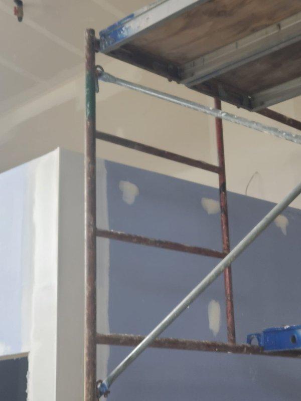 Conducted a comprehensive site assessment for HVAC new construction estimate at an interior renovation project. Evaluated installation requirements in a partially completed space with ongoing drywall work and scaffolding in place. Documented existing conditions and determined optimal placement for HVAC components based on the current construction phase.