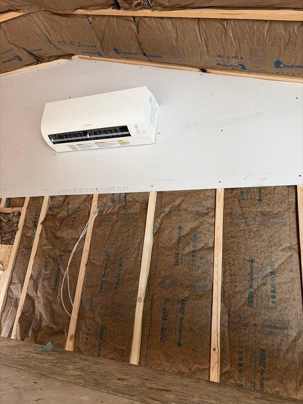 Successfully installed a mini-split air conditioning system on a newly constructed drywall section, with the indoor unit properly mounted and secured. Completed installation of metal conduit with electrical wiring to power the system, ensuring proper routing and secure attachment to the concrete block wall. Documented installation with photos showing both the interior unit installation and exterior conduit work prior to finalizing the project.