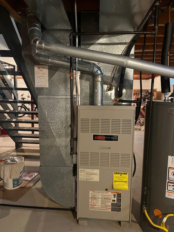 Completed furnace and AC replacement for a customer referral. Installed new Lennox furnace unit in basement utility area, connecting to existing ductwork system, and replaced aging outdoor AC condenser unit which was mounted on concrete pad with proper electrical connections.