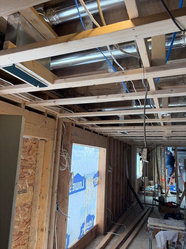 Completed rough-in installation of HVAC system in new construction, including running sleeves and linesets through wood framing. Installed dual Lennox furnace units in mechanical room with proper PVC venting, copper linesets, and connections to ductwork. Documented installation with photos showing both the rough-in work through framed walls and the completed mechanical room setup.