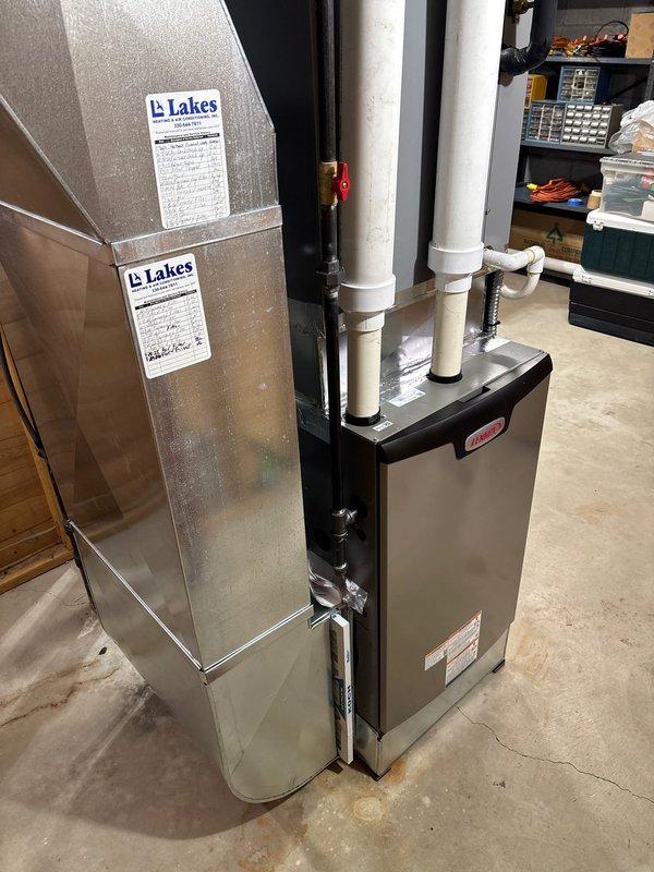 Completed retrofit installation of Lennox furnace system in basement utility area. Installed new PVC intake and exhaust venting, connected all electrical components and condensate drain lines, and secured proper ductwork connections with Lakes-branded components. System was properly mounted with appropriate clearance for maintenance access and verified to be in proper working condition.