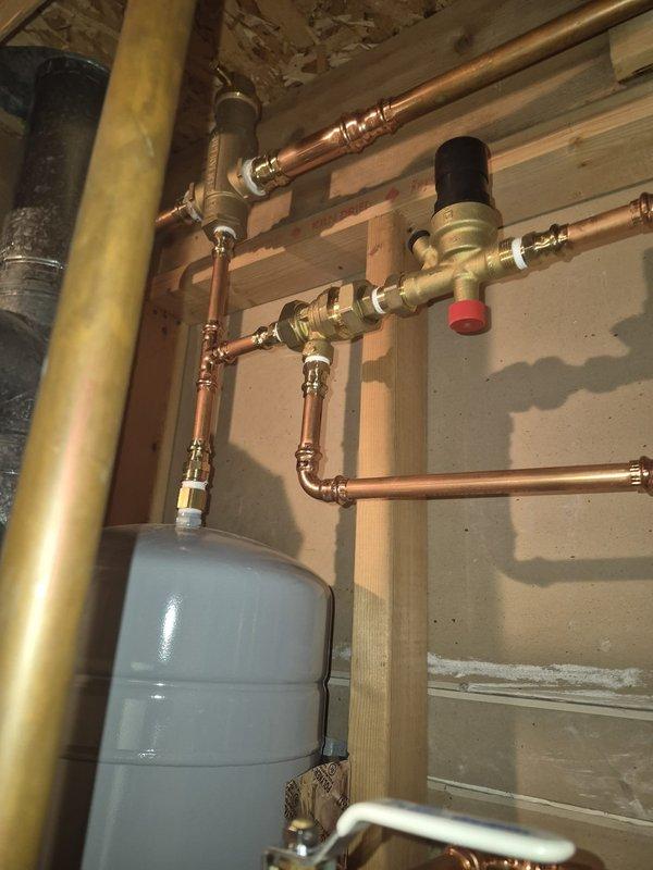 Investigated humidifier water leak reported by customer after previous service. Inspected copper plumbing connections and valves serving the humidifier system. Found and repaired loose fitting at humidifier water supply line. Checked operation of Rheem water heater and expansion tank - both functioning properly with no additional leaks detected.