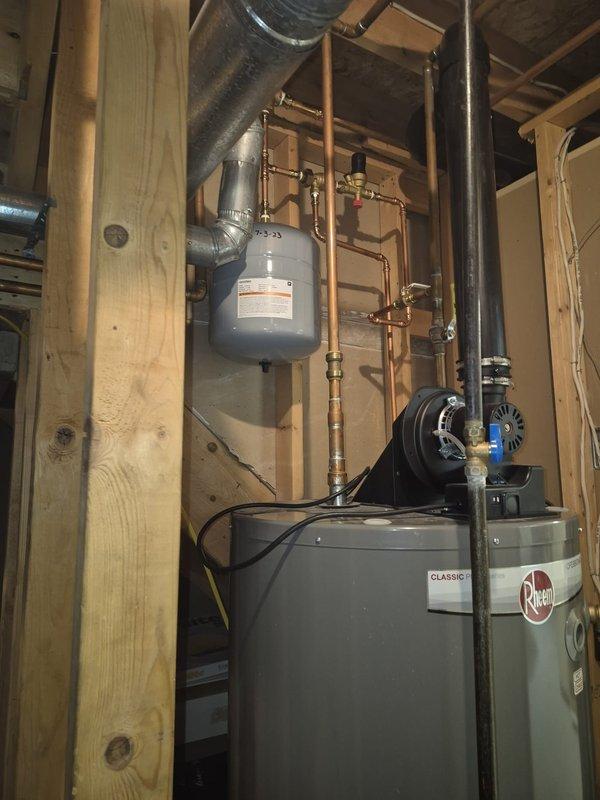 Investigated humidifier water leak reported by customer after previous service. Inspected copper plumbing connections and valves serving the humidifier system. Found and repaired loose fitting at humidifier water supply line. Checked operation of Rheem water heater and expansion tank - both functioning properly with no additional leaks detected.