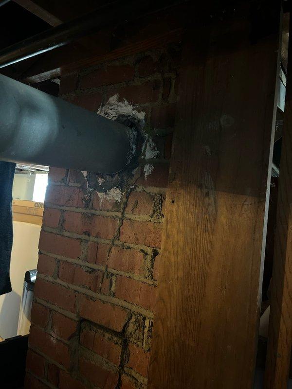 Completed full system replacement for new customer, installing new furnace unit with complete ductwork integration through existing brick wall penetration. Sealed duct-to-wall connection points with appropriate sealant and ensured proper installation of all refrigerant lines, gas connections, and electrical components in the utility area.