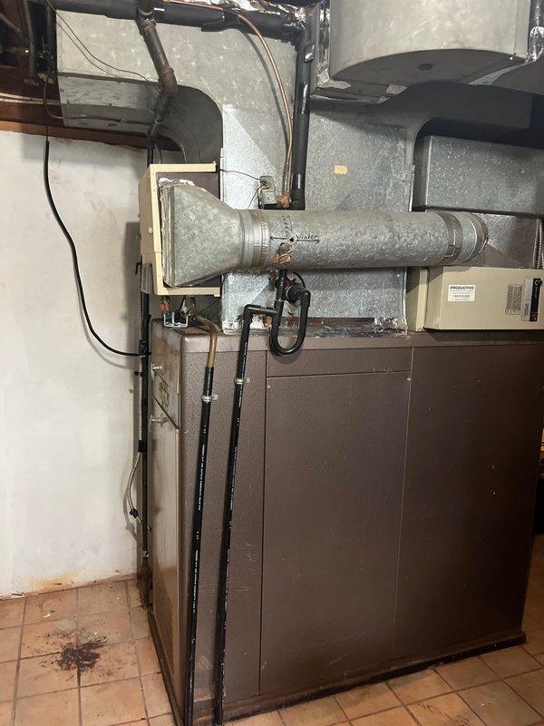 Completed full system replacement for new customer, installing new furnace unit with complete ductwork integration through existing brick wall penetration. Sealed duct-to-wall connection points with appropriate sealant and ensured proper installation of all refrigerant lines, gas connections, and electrical components in the utility area.