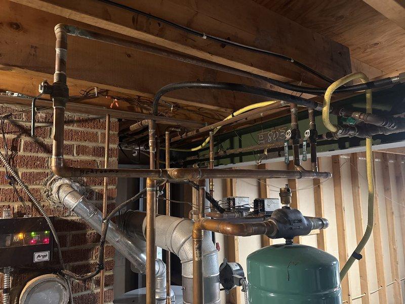 Performed routine furnace clean and check in residential utility area. Inspected all plumbing connections, HVAC components, and control systems. Verified proper operation of pressure tank and ventilation system with circular damper, ensuring all systems are functioning according to manufacturer specifications.