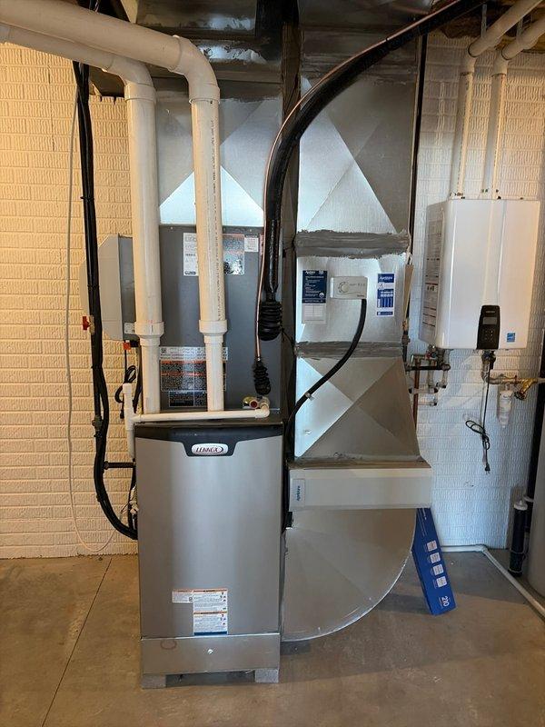 Completed final installation of a Lennox furnace system with associated ductwork in the residential mechanical room, ensuring proper connections to existing plumbing and electrical systems. Installed kitchen ventilation system with metal range hood and ductwork between windows, completing the HVAC new construction finish requirements for the property.