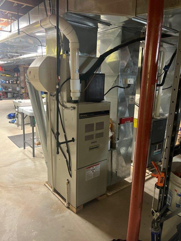 Conducted inspection of aging furnace system in basement utility room that customer reported was producing excessive noise during operation. Examined existing HVAC setup, which includes central furnace unit with extensive ductwork distribution system and standard residential connections. Recommended complete replacement of the furnace unit due to age-related deterioration and operational inefficiency, while maintaining compatibility with the existing ductwork configuration.