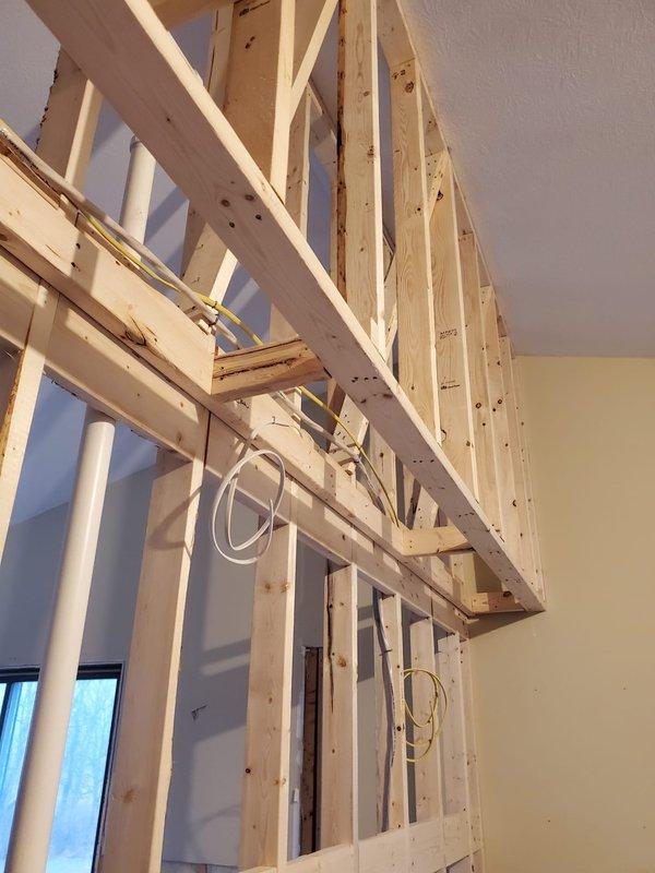 Conducted inspection of exposed framing to evaluate installation requirements for bathroom exhaust fans, microwave exhaust, and associated ductwork. Documented existing structural conditions with photos, noting electrical wiring paths and available connection points through wooden joists. Performed preventative maintenance on system components affected by snow accumulation.