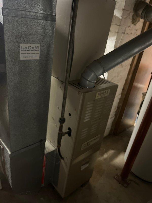 Performed furnace and AC retrofit on existing residential HVAC system. Installed new LACAN air handler unit alongside replacement HEAT-branded furnace with PVC exhaust ventilation in basement utility area. Exterior inspection confirmed proper connection to existing outdoor condensing unit mounted adjacent to foundation.