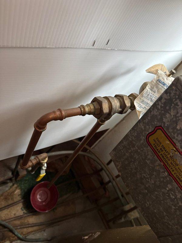 Responded to service call for boiler leak. Inspected system and identified failed brass valve assembly on copper supply line. Replaced defective valve, pressure tested connections, and verified proper system operation with no further leaks observed.