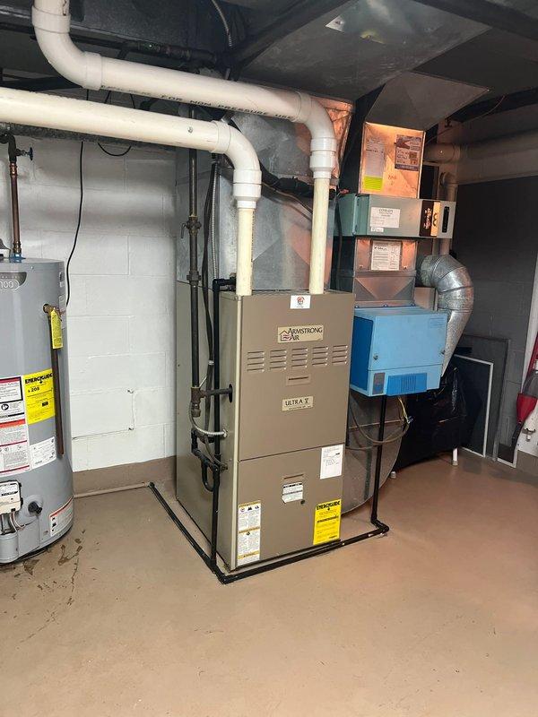 Completed furnace and AC retrofit on existing residential system. Replaced aging outdoor condensing unit, which showed visible wear, with new unit properly installed on existing concrete pad with electrical disconnect. Interior work included replacement of furnace unit in mechanical room, ensuring proper connection to existing ductwork and PVC venting system.