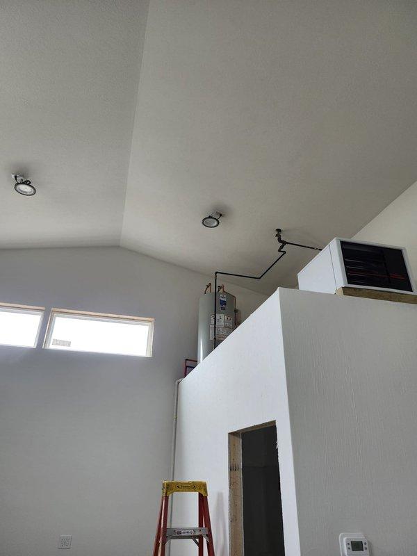 Conducted inspection of water heater venting system installed above bathroom area. Verified proper installation of hot and cold water lines, examined black venting pipes for proper routing and clearances. No issues requiring immediate attention were identified during this preventative maintenance visit.