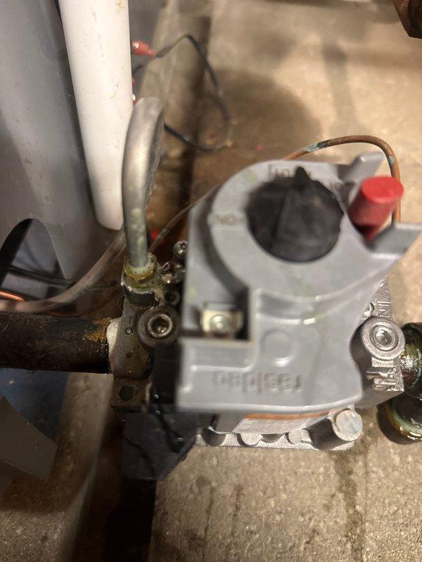 Responded to service call for a boiler making unusual noise. Upon inspection, found significant corrosion on horizontal pipes and control valve assembly with mineral buildup at connection points. Observed advanced oxidation and galvanic corrosion at brass/copper fittings, indicating long-term moisture exposure or possible slow leak causing deterioration of metal components.